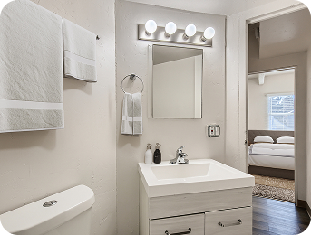 Bathroom vanity and mirror at Julian Square Apartments