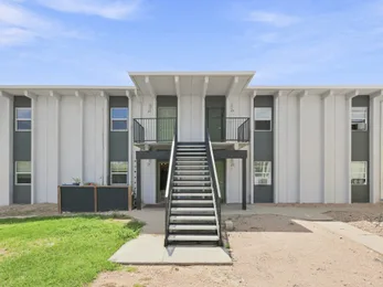 Julian Square building front view with green entry doors