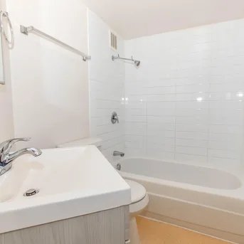 Julian Square Apartments bathroom with tub and vanity