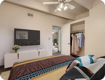 Bedroom with TV and closet at Julian Square Apartments