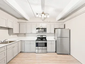 Kitchen with stainless steel appliances at Julian Square Apartments