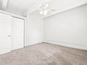 Carpeted bedroom at Julian Square Apartments